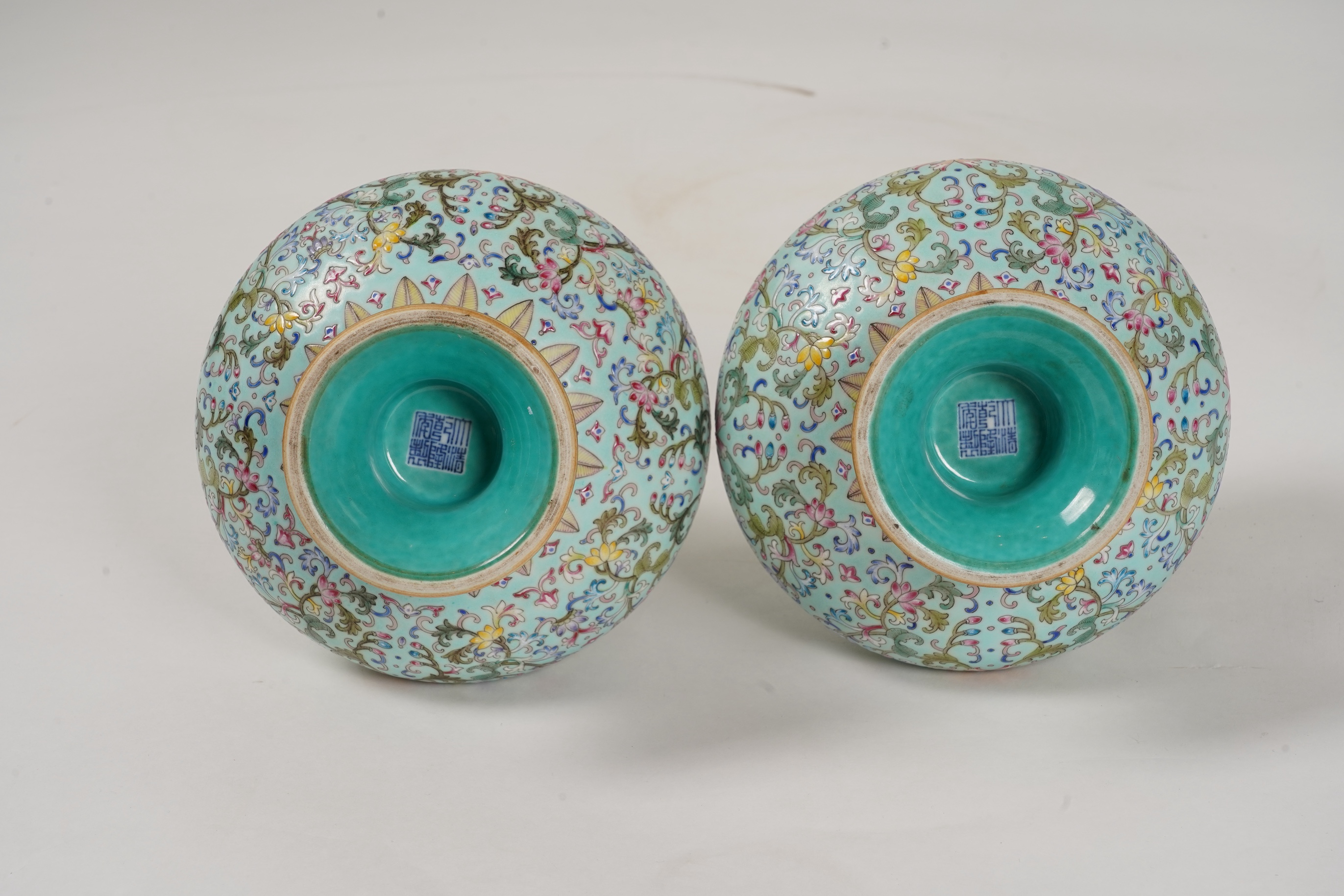 A pair of Chinese famille rose enamelled porcelain bottle vases, Qianlong seal mark to base but Republic Period